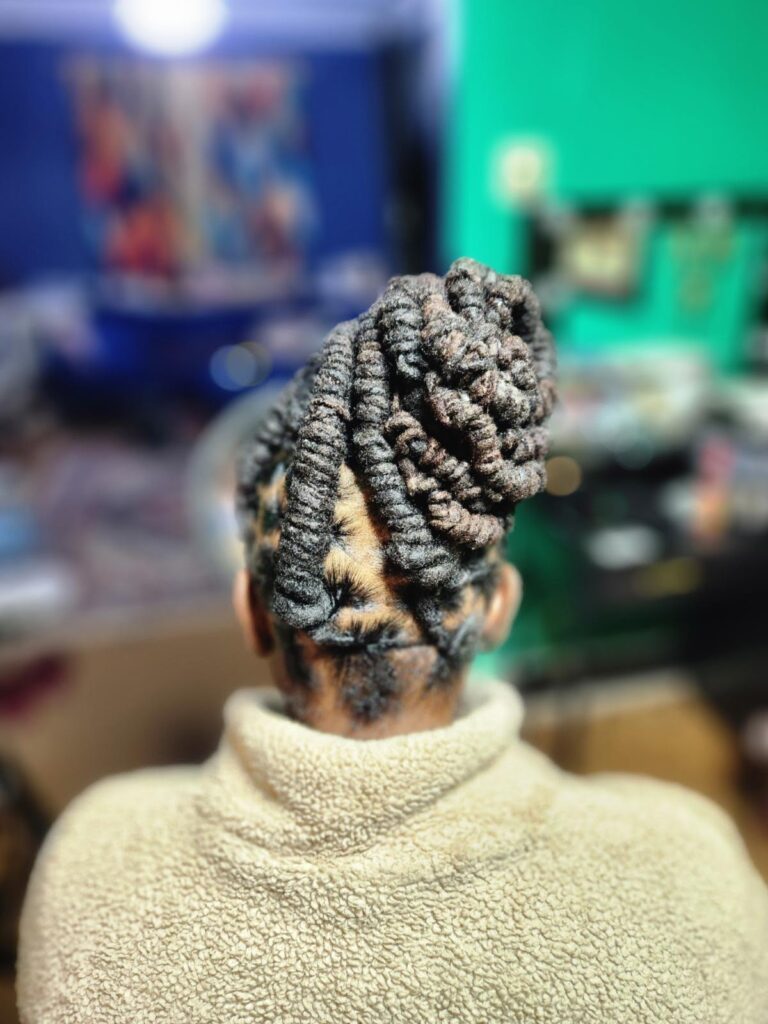 A woman with styled locs side view.