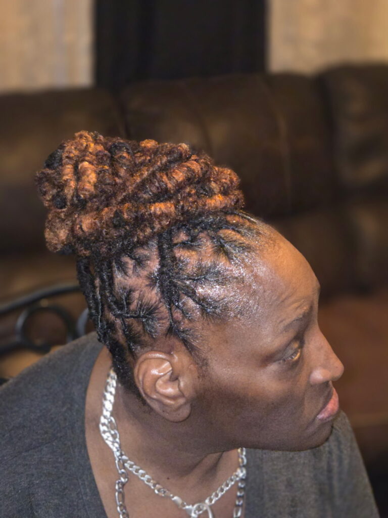 A after image of a woman who needed a reinstall loc service at The Queens Den of Isan's Naturals,