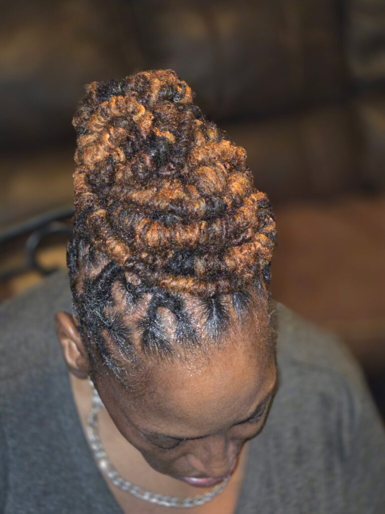 An after image of a woman who needed a reinstall loc service at The Queens Den of Isan's Naturals,