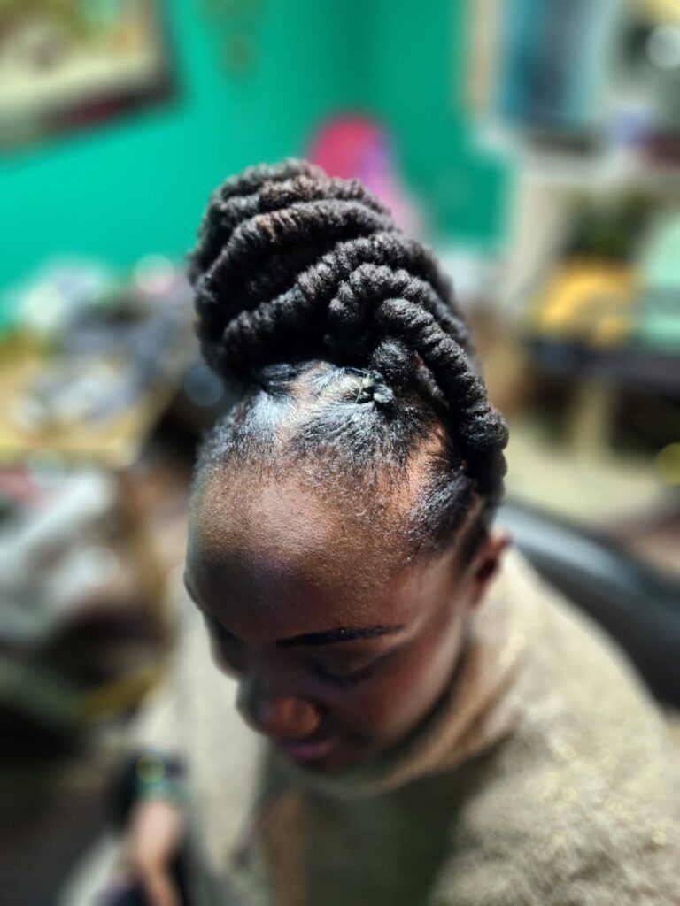 A woman with styled locs.