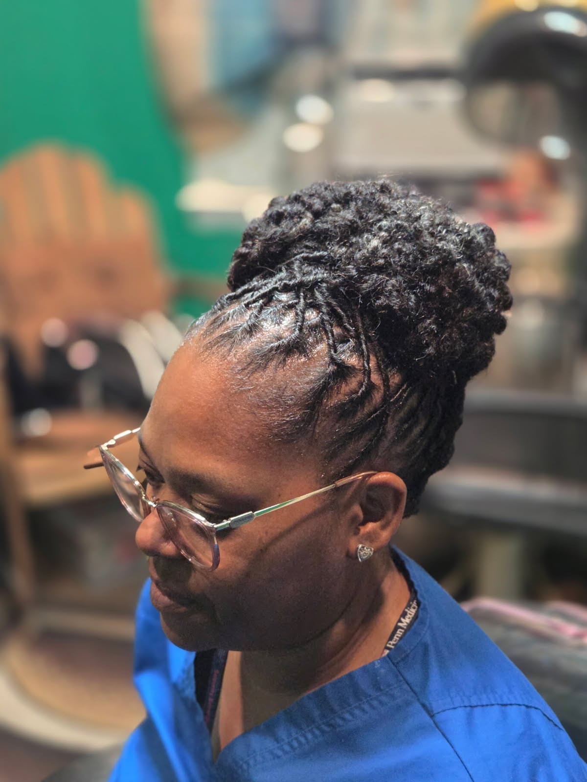 A woman with styled locs side view.