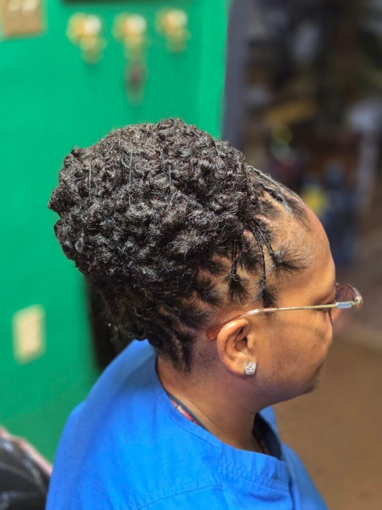 A woman with styled locs side view.