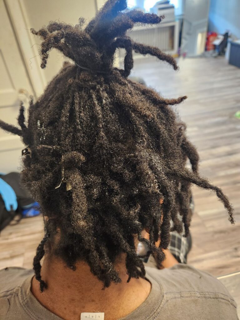 The before photo of before and after loc photos: Photo of a person's hair done neatly